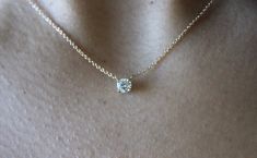 "This classic necklace features a round floating diamond basket set. Beautiful solitaire diamond necklace, perfect for a sparkly everyday look. *4 mm= .25 carats approximately. *4.4 mm= .33 carats approximately. *4.8 mm= .40 carats approximately. * Handmade in the USA. * Gold KT: 14K/18K gold. * Diamonds: Round Diamond * Color and Clarity: H (or better) / SI2 (or better). * Chain type: 1 mm cable chain, Lobster clasp. * Chain length: 15\"-16\", 17\"-18\". * Setting Type: Basket Setting. * Made t Round Diamond Necklace, Solitaire Diamond Necklace, Diamond Choker Necklace, Basket Setting, Diamond Solitaire Necklace, Classic Necklace, Basket Set, Necklace Box, Solitaire Diamond