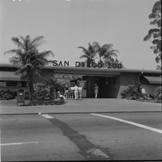 an old photo of people standing in front of the san diego train station with palm trees