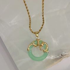 18K gold, stainless steel set with light green Jade stone Meaning: The dragon enhances your intuition in recognizing others' bad intentions and ensures that this flow of good energy remains safe from those who seek to take it from you. It enables the wearer to convey strength, power, and confidence.