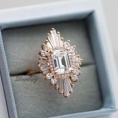 an engagement ring in a box with diamonds on the sides and inside, that looks like it has been cut into smaller pieces