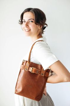 Brown Leather Bag, Leather Handbag, Leather Tote, Bags and Purses, Brown Handbag, Bucket Bag Stylish, yet practical Small Handbag for everyday use 👜 The innovative design of this bag is completely made by us. Our every bag is different, handmade and therefore unique 💓 The ultimate everyday Handbag! * Simple, Elegant * High Quality, Soft natural leather * Safe - Front buckle and button snap closing mechanism. * Interior pocket with zipper * No lining * Size in the pictures: Small * Color: Dark Cognac Satchel Shoulder Bag With Brass Hardware, Brown Leather Strap Crossbody Bag, Brown Vegetable Tanned Leather Saddle Shoulder Bag, Everyday Brown Vegetable Tanned Leather Saddle Bag, On-the-go Leather Shoulder Bag With Leather Strap, Office Tote Shoulder Bag With Brass Hardware, Brown Leather Tote Saddle Bag, Leather Shoulder Bag With Leather Strap For On-the-go, Cognac Leather Saddle Bag In Tote Shape