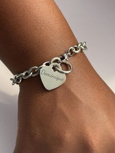 Delight in the timeless elegance of the Personalized Stainless Steel Heart Bracelet, a perfect accessory for any occasion. Constructed from 316L Surgical Grade Stainless Steel, this bracelet is designed to withstand daily wear without tarnishing or causing skin discoloration. It is water-resistant, making it ideal for wearing in the shower or pool. Available in 7-inch and 8-inch lengths and measuring 1/4 inch wide (7mm), it ensures a comfortable fit for everyone. Features: Material: Made from 316L Surgical Grade Stainless Steel that won't tarnish or turn skin green, ensuring long-lasting wear and durability. Lengths: Available in 7-inch and 8-inch lengths to provide a perfect fit for every wrist. Width: The bracelet measures 1/4 inch wide (7mm), offering a sleek and elegant look. Heart Cha Silver Chain Bracelet For Mother's Day, Custom Bracelet, Skin Discoloration, Custom Bracelets, Girlfriend Gift, Heart Bracelet, Gift For Wife, Steel Bracelet, Chain Link Bracelet