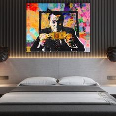 a bed with a painting on the wall above it