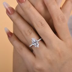 a woman's hand with a diamond ring on it