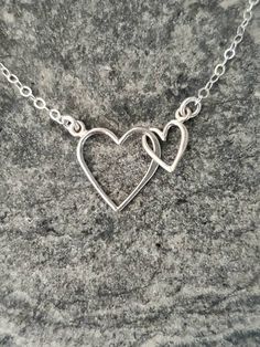 "Beautiful Sterling Silver double heart pendant. Perfect for mother/ daughter necklace or makes a great Mother's Day or Valentine's Day gift. The shiny Sterling Silver hearts are attached together but move loosely and independent of each other. Each heart is attached to a sterling silver chain and has a sterling silver spring clasp in back. Shown here in 17\". *If you are unsure of the length you need, or would like to wear this item at different lengths, we now offer an adjustable length option Mother's Day Double Heart Necklace With Heart Beads, Double Heart Necklace With Heart Beads As Gift, Nickel-free Double Heart Necklace For Anniversary Gift, Handmade Double Heart Jewelry For Anniversary, Double Heart Beads Necklace Gift, Double Heart Beads Necklace For Gift, Handmade Open Heart Necklace For Anniversary Gift, Mother's Day Jewelry With Double Heart Charm, Mother's Day Heart Necklace With Heart Pendant And Beads