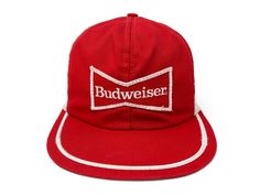 Vintage Budweiser hat. Trucker-style fit with a snapback closure and patchwork graphics Brand: Illegible (faded) Size: Adjustable (One Size Fits Most) Condition: Good Flaws: Faint staining to sweatband. Minor staining to underside of brim. Wrinkling to face Vintage Summer Dad Hat With Flat Bill, Retro Hat With Logo Patch For Baseball Season, Retro Flat Brim Hat With Logo Patch, Retro Flat Bill Hat With Logo Patch, Retro Hat With Flat Bill And Logo Patch, Retro Baseball Cap With Logo Patch And Curved Brim, Retro Adjustable Six-panel Dad Hat, Retro Six-panel Baseball Cap, Retro Snapback Hat With Logo Patch And Curved Brim