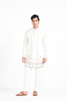 Ivory Phulkari inspired Nehru Jacket with pipe, cutdaana and thread work embroidery with same coloured kurta with embroidery detail on the chest and sleeve. this set in made in linen Satin, Paired with Ivory slim fit Pant Pajama. Color of
the actual garment may vary due to lighting conditions during the shoot.

Size Chart For Men





	
	
					Men's Size Chart
		

		
		
						
				Size Chart For Men
				Custom Size Measurement Guide
			
			
				
				
				Custom Size Measurement Guide
1. Take you Elegant Bandhgala With Embroidered Border For Festivals, White Semi-stitched Nehru Jacket For Festivals, Long Sleeve Chikankari Embroidered Fabric For Navratri, Long Sleeve Embroidered Fabric With Chikankari For Navratri, Fitted Sherwani With Embroidered Border For Transitional Season, Traditional Embroidered Bandhgala For Wedding, Festive White Semi-stitched Nehru Jacket, Traditional White Nehru Jacket With Floral Embroidery, White Bollywood Bandhgala For Designer Wear