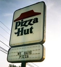 a sign for a pizza hut with the word we have pizza on it's side