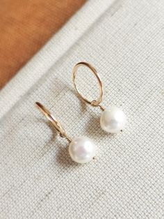 These dainty freshwater pearl hoops are the perfect accessory to complete that minimalist modern look! Great to give as a gift or to treat yourself! --------------------------- D E T A I L S * Earrings are made out of 14k gold-fill wire - Great for those sensitive to specific metals - Lightweight for easy wear * Hand-shaped rounded wire (14mm in diameter - 1.20mm thick) * Pearls measure 8mm * Ethical sourcing of all materials * Packaged neatly + securely in a reusable drawstring bag - ready to g Delicate Hoop Earrings With Pearl Charm For Everyday, Minimalist Teardrop Hoop Earrings With Pearl Charm, Delicate Everyday Hoop Earrings With Pearl Charm, Minimalist Pearl Charm Hoop Earrings For Everyday, Minimalist Hoop Pearl Earrings With Ear Wire, Minimalist Everyday Hoop Earrings With Pearl Charm, Minimalist 14k Gold-filled Hoop Earrings With Pearl Charm, Minimalist 14k Gold Filled Small Hoop Pearl Earrings, Small Hoop Minimalist Earrings With Pearl Charm