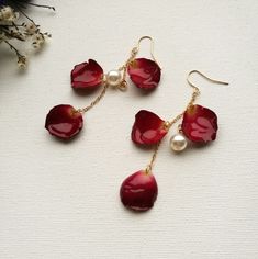 "Material: Real dried rose petal and coated with resin. Gold plated brass with faux pearls. Light weight and sturdy. Length: 2.95\"  Don't have ear holes? Don't worry, we have invisible clip on ear clips. Hand picked red rose petals, thick and perfect shape. Every petal is unique, the color might not same.  It come in gift box. Free shipping on order over 35( U.S. only)" Flower Red Rose, Flower Resin Jewelry, Red Rose Petals, Resin Jewelry Diy, Resin Jewelry Making, Flower Red, Pearl Dangle Earrings, Jewelry Lookbook, Pearl Earrings Dangle