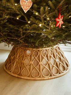 a christmas tree in a basket with ornaments on it