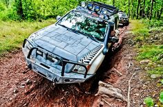 an off - road vehicle is stuck in the mud