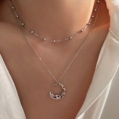 Discover the enchanting allure of our Dainty Gothic Moon Necklace. Featuring a striking silver half moon pendant, this layered necklace set offers a perfect blend of gothic charm and minimalist elegance. Crafted from high-quality sterling silver, it adds a touch of sophistication and mystique to any outfit. Ideal for layering or wearing alone, this versatile necklace makes a thoughtful and stylish gift for her, whether for a birthday, anniversary, or special occasion. Celebrate her unique style Moon Phase Choker Necklace, Metal Necklaces With Moon Phase, Silver Double Chain Layered Necklace, Silver Layered Double Chain Necklace, Silver Moon Charm Choker Necklace, Elegant Layered Necklace With Moon Charm As Gift, Silver Choker Necklace With Moon Charm, Elegant Silver Half Moon Necklace, Silver Layered Moon Charm Necklace For Gift