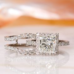 an engagement ring with a princess cut diamond in the center