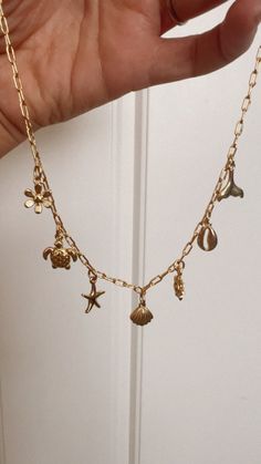 In stock! This is a pre made charm necklace! You will get the necklace as shown! Designed with high quality and durability in mind, the Pre-Made Beach Vibes Charm Necklace comes with multiple charms to complement any outfit or style. Its 16" chain ensures a comfortable fit for any neck size while still providing a stunning and fashionable look. Gold filled charm necklace & charms. 16” chain Cute Beachy Jewelry, Scandi Jewellery, Charm Necklace Ideas, Preppy Necklaces, Jewelry Product Shots, Surf Jewelry, Nail Bracelet, Beachy Jewelry, Preppy Jewelry