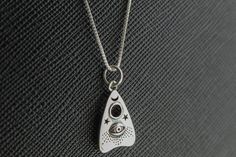 Such a fun little charm necklace. I am a huge fan of Halloween and this a great piece to wear anytime! DETAILS * The Box chain and all components are .925 sterling silver. * The tiny planchette is sterling silver and measures 10mm Birthstone add on https://www.etsy.com/listing/592013303/birthstone-add-on-minimalist-tiny?ref=shop_home_active_1&frs=1DETAILS C A R E ∙ T I P S We don't want your special moment to fade. To maintain the quality of your new Mathew & Marie Co. jewelry, please: * Halloween Teardrop Jewelry Gift, Handmade Black Sterling Silver Charm Necklaces, Sterling Silver Witchy Necklace For Gift, Witchy Sterling Silver Necklace For Gift, Witchy Sterling Silver Jewelry For Gift, Ouija Board Planchette, Ghost Hunter, Spirit Board, Ouija Board