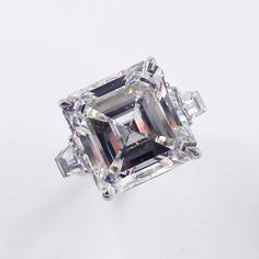 an emerald cut diamond with three baguets on the side and two diamonds in the middle