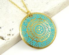 Turquoise and gold medallion necklace features a round gold disc embossed with an ornate design and colored with turquoise enamel. Pendant has a distressed feel with some dark areas on the pendant. This is part of its style. Pendant is 1 3/16 inches in diameter (30mm). Your choice of chain lengths - 18 or 20 inches. Find more necklace styles here - https://www.etsy.com/shop/CharleneSevier?ref=hdr_shop_menu&section_id=10084290 Necklace Styles, Gold Medallion Necklace, Long Necklace Boho, Turquoise And Gold, Sterling Silver Heart Pendant, Ornate Design, Gold Medallion, Wood Bead Necklace, Gold Disc