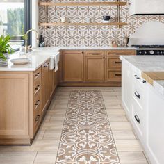 a kitchen with wooden cabinets and tile flooring on the walls, along with white counter tops