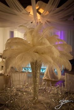 the centerpiece is decorated with white feathers