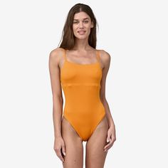 Our bandeau-inspired, reversible one-piece swimsuit has a versatile strap system that can be worn tied over the shoulders or crossed in back for a more secure fit. Made in a Fair Trade Certified™ factory. | Patagonia Women's Reversible Sunrise Slider One-Piece Swimsuit in Kishu Orange, Large - Surf Swimwear - Recycled Nylon/Recycled Polyester/Spandex Summer Bandeau Bodysuit With Built-in Bra, Summer Swimwear With Built-in Bra And Tank Straps, Summer Nylon Bodysuit With Tank Straps, Trendy Solid Color Swimwear With Lined Body, Solid Beachwear Bodysuit With Adjustable Straps, Solid Color Bandeau Swimwear With Adjustable Straps, Trendy Solid Swimwear For Swimming, Trendy Swimwear With Spaghetti Straps And Lined Body, Trendy Solid Color Swimwear For Swimming