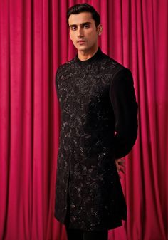 Step into the spotlight with our Black Floral Embroidered Sherwani Set. This exquisite ensemble features a heavily embellished achkan, adorned with large geometrically hand-embroidered floral work. Paired with a kurta and bell-bottom pants, it exudes elegance and sophistication. Perfect for weddings and festivals, this sherwani set will make you the centre of attention. Ideal for grooms and members of the groom's family, this set is sure to impress. Composition : Jacket, Kurta & Pants: Premium Suiting Care: Dry Clean Only and Vacuum Storage This product can be customized for sleeves, length of blouse and neckline Delivery : 4-6 weeks as the product is hand crafted. Check Size Guide or choose MySize for free customisation (All Sizes above XL can be made at 15% additional cost) For more info Festive Straight Kurta Bandhgala For Reception, Festive Bandhgala With Chikankari Embroidery For Designer Wear, Reception Bandhgala With Zari Work, Designer Embroidered Bandhgala With Straight Kurta, Designer Embroidered Kurta For Diwali, Embroidered Straight Kurta Bandhgala For Reception, Festive Designer Sherwani With Chikankari Embroidery, Designer Nehru Jacket With Chikankari Embroidery, Unstitched Festive Nehru Jacket For Reception