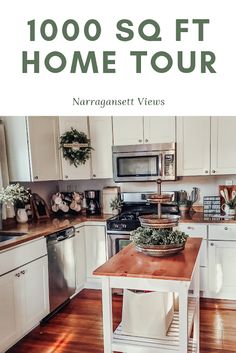 a kitchen with white cabinets and wood floors, has a wooden table in front of the stove