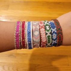 a woman's arm with several bracelets on it