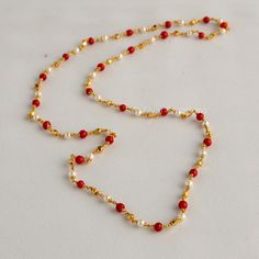 Embrace the allure of tradition with our Coral Pearl Necklace--a fusion of antique charm and Jaipuri elegance. This Mala set, a blend of traditional and fancy elements, features vibrant coral color beads and lustrous pearls. The necklace exudes sophistication, complementing any outfit effortlessly.  This personalized jewelry piece is my own design, and I welcome any customization requests. Elevate your style with this exquisite Indian jewelry. Length - 30 inch Pearl Coral Necklace Indian, Indian Coral Jewellery Gold, Coral And Pearl Jewellery, Pearl And Coral Gold Chain, Temple Necklace With Pearl Chain As Diwali Gift, Pearl Chain Necklace For Diwali Gift, Festive Pearl Chain Beaded Necklace As A Gift, Elegant Handmade Necklace For Puja, Traditional Festive Necklace With Delicate Chain