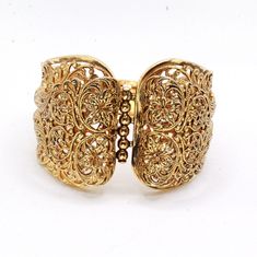 "DESCRIPTION: Step into the charm of the 1970s with this vintage gold-tone filigree bracelet. Crafted with meticulous attention to detail, the bracelet features intricate filigreed patterns adorning the entire piece. The centerpiece showcases a captivating butterfly accent, adding a whimsical touch to the design. In mint condition, this bracelet has been well-preserved over the years, maintaining its original allure. With a push-pull clasp for secure fastening, this bracelet measures 7 1/2\" in Vintage Yellow Gold Cuff Bracelet With Intricate Design, Elegant Antique Gold Bangle, Yellow Gold Brass Bangle With Intricate Design, Vintage Gold Filigree Bracelet For Wedding, Gold Victorian Cuff Bracelet With Intricate Design, Gold Ornate Brass Cuff Bracelet, Brass Bracelets With Intricate Design, Brass Bracelet With Intricate Design, Gold Victorian Bangle With Intricate Design