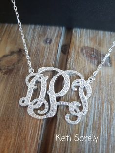 "Customize this beautiful necklace with your initials and it will shine with sparkling Cubic Zirconia stones. Great gift for birthday, graduation, Christmas, anniversary, etc.  Metal: Sterling Silver with Rhodium overlay Monogram size size is optional from 0.5\" to 2\" in diameter. Chain - standard link. Stones - CZ stones Traditional monograms are made with the following order of initials taken from your name: FIRST, LAST, MIDDLE We assume that this is the order that you want your initials in u Elegant Silver Jewelry With Initials, Elegant Silver Initials Jewelry, Elegant Silver Necklace For Birthday, Classic Personalized Cubic Zirconia Necklaces, Elegant Silver Initial Pendant Custom Necklace, Elegant Silver Custom Necklace With Initial Pendant, Elegant Initial Necklace For Birthday, Custom Silver Name Necklace For Wedding, Classic Silver Initial Necklace For Formal Occasions