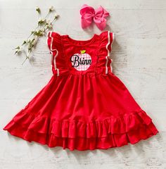 This listing is for the cutest red back to school dress!! Also Available in royal blue!! This is a cute ruffled red pinafore style dress. **This has a cute pink plaid VINYL apple with your choice of a personalized name or no name. You can also choose monogram initials.This is running true to size maybe slightly generous on top and hits to the knee or a little above. (See last picture for fit.) I think this could be paired with red ruffled shorties for a complete outfit or cute leggings. Last pic Fun Short Sleeve Twirl Dress With Ruffles, Fun Ruffled Short Sleeve Twirl Dress, Fun Red Ruffled Dress, Sweet Red Short Sleeve Dress, Cute Ruffle Sleeve Dress For Playtime, Cute Ruffle Sleeve Playtime Dress, Casual Ruffled Dresses For School, Cute Ruffled Pinafore Dress For Summer, Cute Summer Pinafore Dress For Playtime