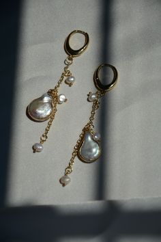 Item Overview ‧͙･༓☾ * Handmade item * Ships worldwide from Alexandria, Virginia Item Details ‧͙･༓☾ Ethereal oval hoop Pearl drop earrings. Beautiful combination of baroque pearls and freshwater pearls to create this gorgeous drop earring. Very trendy and unique and is a great staple to have in your collection. Lightweight design suited for everyday. * Brass, 14k Gold Plated, Baroque Pearl, Freshwater Pearl * 8.25 cm * Moon Made ⟡ Thank you very much for stopping by. Come back soon! ͙･༓☾ mackpear Pearl Teardrop Chandelier Earrings For Pierced Ears, 14k Gold Filled Drop Earrings With Pearl Charm, Pear-shaped Pearl Chain Earrings For Gift, Pear Shaped Pearl Chain Earrings For Gift, Teardrop Baroque Pearl Earrings Gift, Handmade Gold Briolette Pearl Earrings, Baroque Pearl Teardrop Earrings For Gift, Gold Drop Pearl Earrings With Charm, Gold Briolette Earrings With Pearl Charm