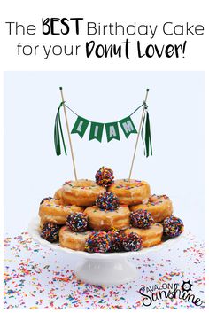 a birthday cake with donuts and sprinkles is on a white plate