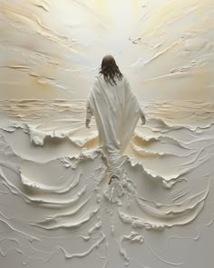 a man with long hair standing in front of a white wall covered in swirls