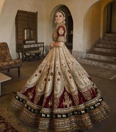 a woman in a red and gold wedding dress