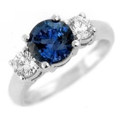 a blue and white diamond ring with three diamonds on the side, set in 18k white gold