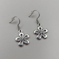 Add a touch of elegance to your outfit with these charming Tibetan Silver Daisy Earrings. The delicate flower shape and hook closure make them perfect for any occasion, whether it's Mother's Day, a wedding, an anniversary, Valentine's Day, or a birthday. These dangle/drop earrings are crafted with nickel-free materials and are handmade in the United Kingdom. These earrings are not only stylish but also personalizable. You can add text to the backing card, like "Daisy The Birth Flower Of April," Elegant Adjustable Flower Earrings, Pierced Flower Earrings For Party, Elegant Hypoallergenic Metal Flower Earrings, Nickel Free Flower Shaped Earrings For Mother's Day, Flower-shaped Nickel-free Earrings For Mother's Day, Nickel-free Flower-shaped Earrings For Mother's Day, Elegant Adjustable Earrings With Flower Decoration, Adjustable Silver Flower Earrings, Silver Adjustable Flower Earrings