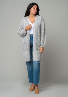 A cozy chunky knit cardigan with braided cable knit detail. FINAL SALE Chunky knit cardigan Relaxed fit Long sleeve with braided cable knit accent Mid-length Open front Side pockets Fall cardigan Your fall and winter wardrobe isn't complete without this chunky knit cardigan. With its cozy long sleeves and braided cable knit accents, it's the perfect blend of comfort and style. The open front and side pockets make it as practical as it is chic. Whether you’re layering over denim or draping it ove Cable Knit Cardigan For Fall And Cold Weather, Gray Cable Knit Sweater Coat For Fall, Cozy Cable Knit Sweater Coat For Layering, Cozy Cable Knit Cardigan For Layering, Cozy Gray Cable Knit Sweater Coat, Gray Cable Knit Outerwear For Fall, Oversized Cable Knit Cardigan For Cold Weather, Oversized Gray Cable Knit Outerwear, Fall Cable Knit Cardigan