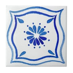 a blue and white tile with an artistic design