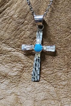 Very pretty unique handcrafted Diamond cut Sterling Silver cross necklace with turquoise setting. 18" stainless steel chain. Spiritual Turquoise Necklace With Cross Pendant Gift, Spiritual Turquoise Cross Pendant Necklace Gift, Adjustable Turquoise Cross Jewelry, Spiritual Cross Turquoise Necklace For Gift, Spiritual Turquoise Cross Necklace As Gift, Spiritual Turquoise Cross Necklace For Gift, Spiritual Turquoise Cross Necklace, Handmade Turquoise Cross Pendant Necklace, Handmade Blue Crucifix Jewelry