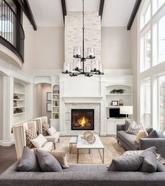 a living room filled with furniture and a fire place in the middle of a room