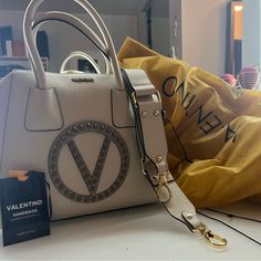 I'm Selling A Valentino Bag, I Don't Really Use It At Most Twice. I Would Like Someone Else To Enjoy It. I Paid Almost $800 Dls I Sell It For Half Price $420 Has All Its Accessories Model Va 9131 High-end White Bag With Adjustable Strap, Designer Satchel With Detachable Strap For Shopping, Designer Beige Bags With Branded Hardware, Designer Cream Shoulder Bag With Branded Hardware, High-end White Bags With Branded Hardware, High-end White Satchel For Shopping, Designer Beige Satchel With Branded Hardware, Designer Satchel With Branded Hardware For Shopping, Luxury Cream Bag With Branded Hardware