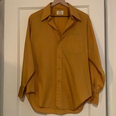 Vintage Mustard Yellow Button Up Shirt Polyester And Cotton Slight Wear At Cuffs, See Photo Small Discolored Spot, I Have Never Worn This So I’ve Never Tried To Get It Out The Care Instructions Are Printed On The Shirt Near The Bottom, See Photo There Is No Size Listed On The Tag 30” Shoulder To Bottom 24” Pit To Pit 23” Sleeve Length Classic Single Breasted Tops For Daywear, Classic Single-breasted Tops For Daywear, Yellow Spread Collar Shirt For Work, Retro Workwear Tops With Button Cuffs, Classic Yellow Button-up Tops, Classic Yellow Shirt With Buttons, Yellow Tops With Button Cuffs For Work, Yellow Workwear Tops With Button Cuffs, Solid Shirt With Button Closure For Daywear