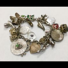 925 Sterling Silver Charm Bracelet W/ Florida, Crew Ship, And Airplane Featured Charms: Clog, Green And Red Holly Leaf, Sneaker, Daughters Of The Nile (Dofn), Florida, Happy Birthday, Bowling Pin And Ball, Motor Cycle, Virgin Islands, "To The Dearest Mother" W/Green Gem Stone, Cross W/7, Heart Charm W/ "Robin", "Touch Wood", Diving Charm, Mickey, Wine Glass, Cable Car, Dog, Masonic Charm, My Valentine, Airplane, Crew Ship, Girl W/Ponytail Good Condition: W/Slight Tarnish Heirloom Style Silver Metal Bracelets, Unique Sterling Silver Jubilee Bracelet, Unique Silver Jewelry With Vintage Charm, Heirloom Silver Bracelet With Vintage Charm, Silver Charm Bracelet In Costume Jewelry Style, Silver Charms Costume Jewelry, Sterling Silver Bracelet With 17 Jewels For Gift, Heirloom Sterling Silver Jewelry With Vintage Charm, Silver Heirloom Jewelry With Vintage Charm