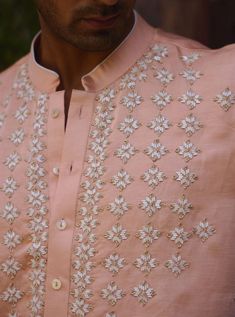 The rambagh kurta in peach is a stylish and refined choice for Indian grooms, perfect for haldi, mehndi, or sangeet ceremonies. Crafted from premium viscose cotton silk, this kurta offers a soft and comfortable feel, ideal for festive occasions. This kurta comes with an ivory salwar, providing a harmonious and classic contrast to the peach tone. The rambagh kurta is ideal for grooms seeking a subtle yet elegant ensemble. Pair with traditional or contemporary footwear for a polished and stylish appearance. Indian Groom, Bespoke Tailoring, Cotton Silk, Twist, Festival, Silk