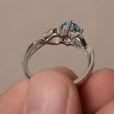 This is a gorgeous handmade creation. Its beauty is its simplicity & Elegance. The 6*6 mm round shape faceted real Swiss Blue Topaz is crafted in solid sterling silver and with rhodium plated. All item is sent in a beautiful gift box If you have any idea of design your ring,pls contact me directly. You can realize more lovely stuff clicking the link https://www.etsy.com/shop/knightjewelry?refshopsection_shophome_leftnav Please leave the correct address and you phone number for delivering suc Sterling Silver Topaz Gemstone Ring, Silver Topaz Ring For Promise, Fine Jewelry, Silver Topaz Ring With Accent Stones, Blue Topaz Solitaire Promise Ring, Silver Blue Topaz Diamond Ring As Gift, Gift Blue Topaz Diamond Ring In Silver, Gift Round Cut Topaz Birthstone Ring, Gift Topaz Birthstone Ring With Round Cut, Promise Topaz Ring