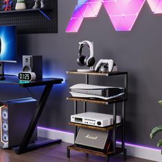 there is a computer desk with headphones on it in the room, and two speakers are sitting next to each other