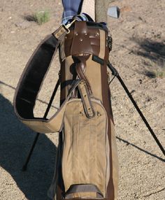 a golf bag sitting on top of a wooden pole