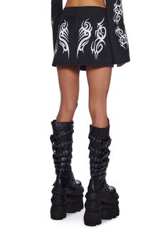 This mini skirt has a reflective tribal design print on the front and back, a low waist fit, and a front zipper closure. Punk Mini Skirt For Club, Edgy Fitted Mini Skirt With Zipper Closure, Punk Mini Skirt With Belt Loops, Black Punk Mini Skirt With Zipper Closure, Black Rave T-shirt With Screen Print, Print Mini Skirt, Utility Belt, Rave Festival, Low Waist